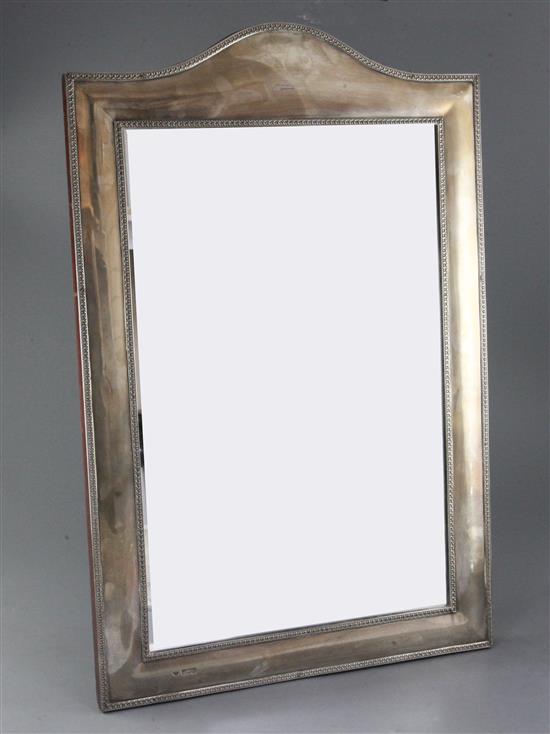 A late Victorian large silver mounted domed top rectangular easel mirror by Goldsmiths & Silversmiths Co Ltd, 65.7cm.